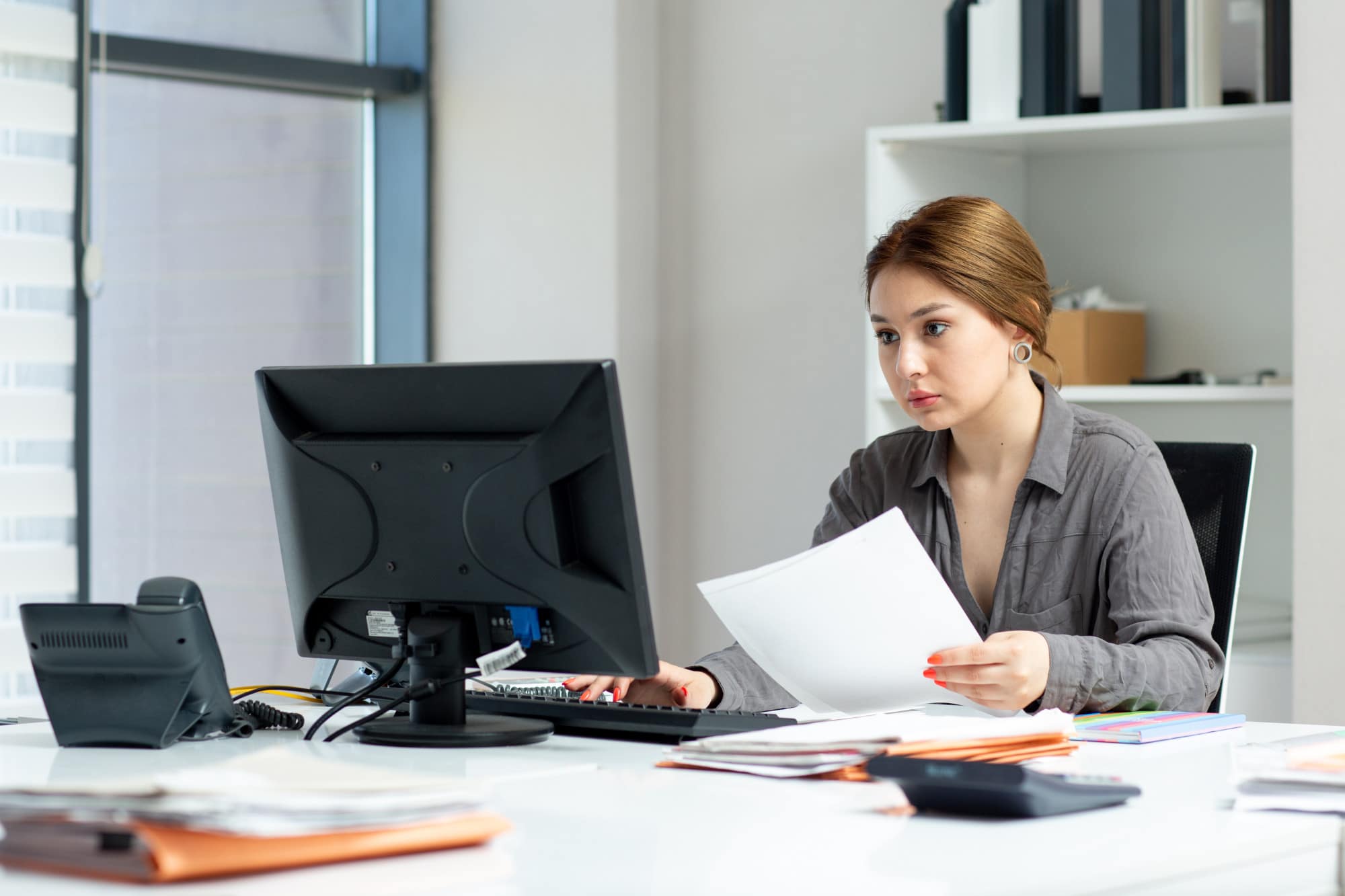 front-view-young-beautiful-lady-grey-shirt-working-her-pc-sitting-inside-her-office-during-daytime-building-job-activity 2